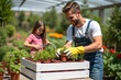 © Amir Bajric - a young couple works in the garden with vegetable seedlings