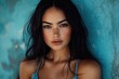 © Lubos Chlubny - Attractive brunette model posing in front of blue wall background