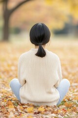 Sticker - Serene Woman in Autumn Leaves: A Tranquil Moment of Reflection and Connection with Nature in a Colorful Fall Setting