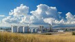 © Theeranan - A panoramic view of an industrial park with metal buildings, storage tanks, and factory equipment under blue skies.