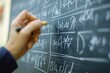 © ckybe - A hand deftly writes intricate equations on a chalkboard, fostering an engaging educational environment.