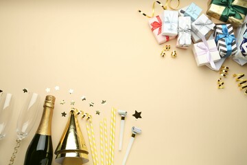 Wall Mural - Flat lay composition with confetti and bottle of sparkling wine on beige background, space for text. Christmas decor