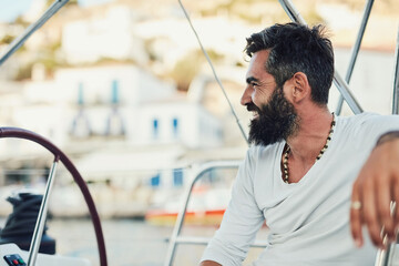 Captain, man and smile on yacht for luxury, fun and adventure in ocean or sea on summer vacation. Male person, happiness and relax on boat for sailing, holiday and travel on water with joy in Monaco