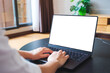 © Farknot Architect - Mockup image of a woman using and typing on computer laptop with blank desktop screen at home