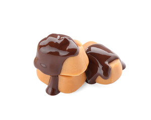 Sticker - Delicious caramel candies with melted chocolate isolated on white