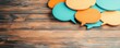© ParinApril - Colorful speech bubbles on a wooden background, ideal for communication, dialogue, and social media concepts.