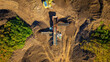 © AmazingAerialAgency - Aerial view of compost screening machine and excavator in a green landscape with dirt and greenery, North Berwick, United Kingdom.