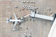 © Amazing Aerial - Canelones, Uruguay - 08 June 2023: Aerial view of Aeropuerto de Carrasco with airplanes on the runway and terminal, Canelones, Uruguay.