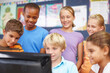 © STEEXBuyout/peopleimages.com - Kids, students and happy in classroom on computer with group work or activity for education. People, classmates and smile as pupil at elementary school with assignment for brain development or growth