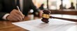 © ParinApril - A gavel placed on a legal document, symbolizing justice and law in a courtroom setting.