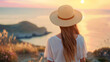 © kichigin19 - an adult girl in a straw hat on the background of the sunset sea view from the back