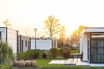 Terraced family homes in newly developed housing estate. The real estate market in the suburbs. New single family houses in a new development area. Residential homes with modern facade.