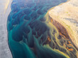 © AmazingAerialAgency - Aerial view of vibrant patterns of a river flowing through pristine sand, Hvolsvollur, Iceland.