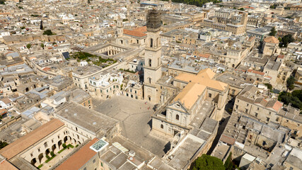 Wall Mural - Aerial view of the cathedral of Lecce, in Apulia, Italy. The metropolitan cathedral of Santa Maria Assunta with its tall bell tower is located in Piazza del Duomo, in the historic center of the city.