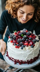 Canvas Print - A woman holding a cake with berries on it