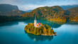 © AmazingAerialAgency - Aerial drone view of Lake Bled with famous church on the island during sunrise, Slovenia