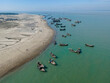© AmazingAerialAgency - Aerial view of fishing boats at fishery ghat along the serene beach of Bay of Bengal, Cox Bazar, Bangladesh.