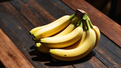 Wall Mural - Bunches of ripe yellow bananas arranged on a rustic wooden surface, highlighting their vibrant color, smooth texture, and natural curves.