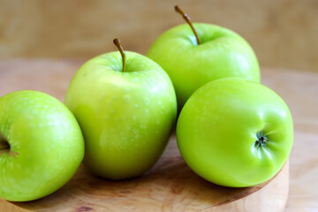 A wooden board with s and greens. Wood table food concept. A wooden board with fruit, s, and greens. A wooden board with fruit and lifestyle greens.