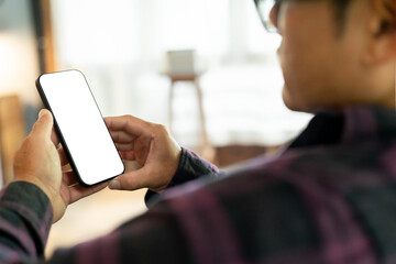 Wall Mural - cell phone blank white screen mockup.hand holding texting using mobile on desk at office.background empty space for advertise.work people contact marketing business,technology