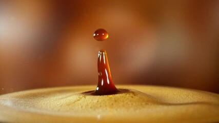 Wall Mural - Super Slow Motion Detail Shot of Coffee Drop Falling into Fresh Espresso at 1000 fps . Filmed on High Speed Cinematic Camera at 1000 FPS .