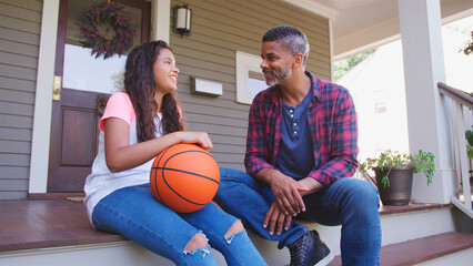 Wall Mural - Father And Daughter Discussing Basketball On Porch Of Home