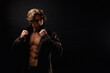 © Alex Vog - Portrait of perfect young man in unbuttoned leather jacket with abs muscle press posing at black shadow. Stylish image guy fashion model with lovely muscular sexy torso studio shot. Copy ad text space
