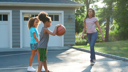 Wall Mural - Mother And Children Playing Basketball Outdoors On Driveway At Home