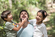 © Antonio Recena - Father playing with his children in forest