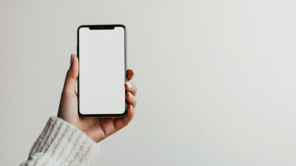 A woman's hand holding a blank smartphone on white background