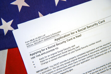 Application for Social Security Card with form on USA flag, background