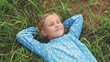 © maxximmm - little girl child lies on the grass in the park. happy family kid dream concept. baby girl in the park lies on her back looks at the sky portrait close-up. girl fun in nature smiling portrait