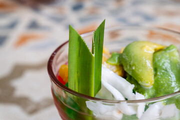 Pandan leaves used as a garnish in cold dessert made with shaved ice, sweet syrups, fruits and jelly