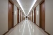 © Nida - Modern hotel corridor with polished white floor, wooden doors, and recessed ceiling lights