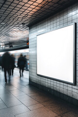 Wall Mural - A blank poster mockup on the wall of an underground station. People walking past in a motion blur. 