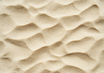 Wall Mural - Aerial view of wind creating wavy pattern on sand dune background