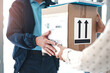 © peopleimages.com - Delivery man, hands and customer with box for ecommerce, distribution and online shopping. Person, courier and giving client package for logistics, mail or receive order for shipping in home closeup