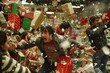 © Наталья Добровольска - Frantic shoppers chasing Christmas deals, consumerism fueled holiday gift race in stores