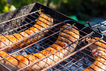 Sausages are fried on the grill