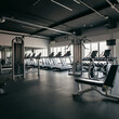 © slice - Empty Gym with Sunlight Through WindowsGym Interior with Modern Equipment