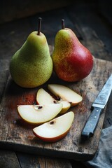 Wall Mural - Fresh pear fruit cut on cutting board with knife