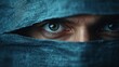 © Tyoma - A man with blue eyes is looking at the camera through a blue cloth