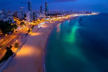 Aerial timelapse of Tel Aviv at night, capturing the bustling nightlife and glowing beachfront