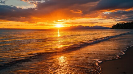 Poster - The sun is setting over the ocean, casting a warm glow on the water