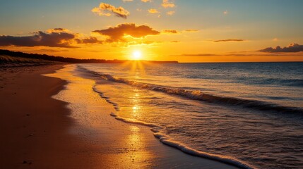 Poster - The sun is setting over the ocean, casting a warm glow on the beach