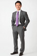 © CreativePulse - A confident Asian businessman in grey suit and purple tie stands with smile, exuding professionalism and charm. His polished look is perfect for corporate settings