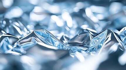 Poster - Close-up view of crumpled metallic foil creating a shimmering texture, reflecting light beautifully for creative backgrounds.
