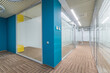© alhim - Working floor in a large corporate office. Original ceiling and floor decor. Glass .cubicles.