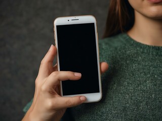 Woman holding a mobile phone with a blank screen.