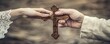 © Alena - Hand passing wooden cross to another. banner